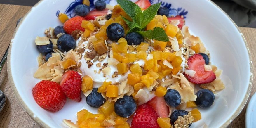 granola bowl with strawberries and blueberries