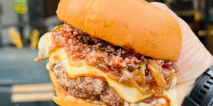 Paulista Burger restaurant dublin - zoom on a smash burger with fried onions and cheese