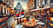 Outdoor pizzeria in Belgrade, Serbia, with freshly baked pizza, drinks, and a cozy setting, featuring Serbian architecture in the background and a small Serbian flag nearby