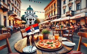 Outdoor pizzeria in Belgrade, Serbia, with freshly baked pizza, drinks, and a cozy setting, featuring Serbian architecture in the background and a small Serbian flag nearby